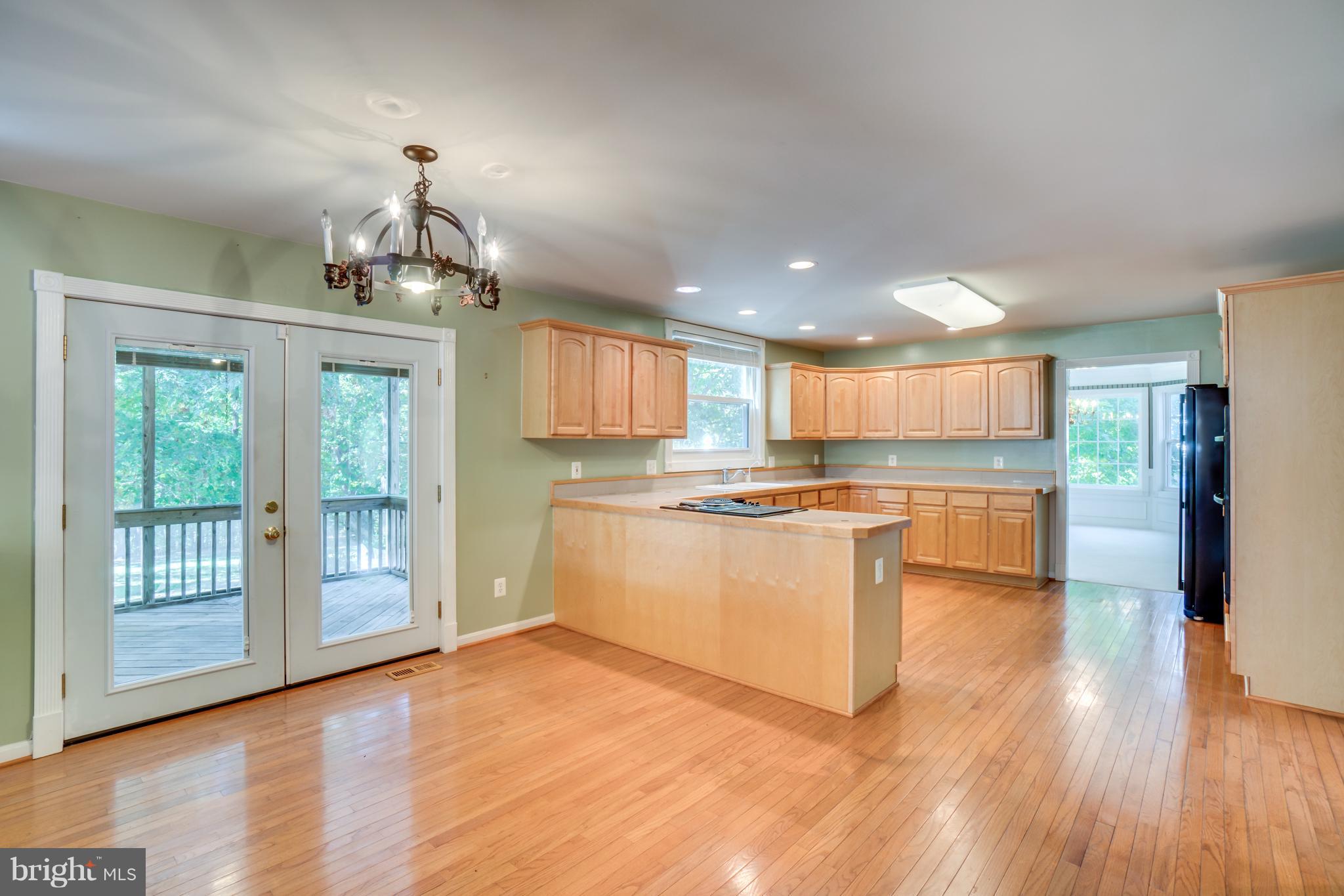 218 Greenbank Road Fredericksburg, VA 22406 - Photo 10 of 20 a large kitchen with cabinets wooden floor and stainless steel appliances