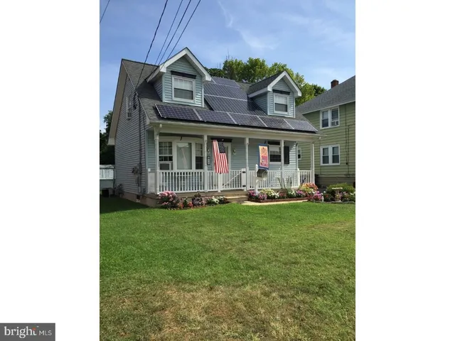 a front view of house with yard and outdoor seating