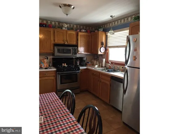 a kitchen with a sink appliances and cabinets