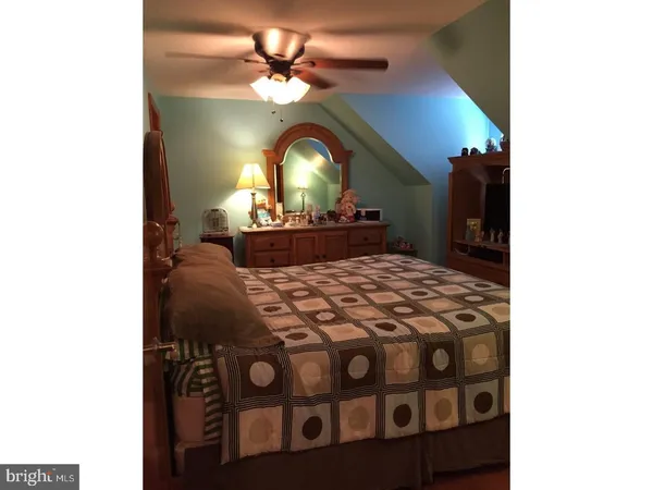 a view of a bedroom with a bed and a chandelier