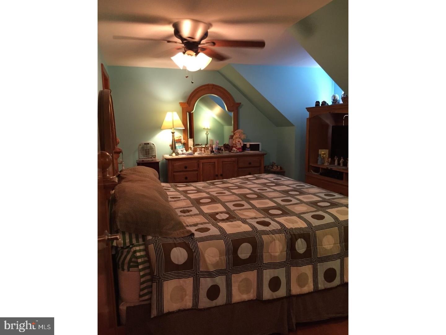 19 College Avenue Glassboro, NJ 08028 - Photo 6 of 12 a view of a bedroom with a bed and a chandelier