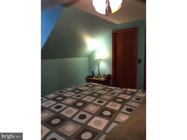 a bedroom with a bed and a lamp on table