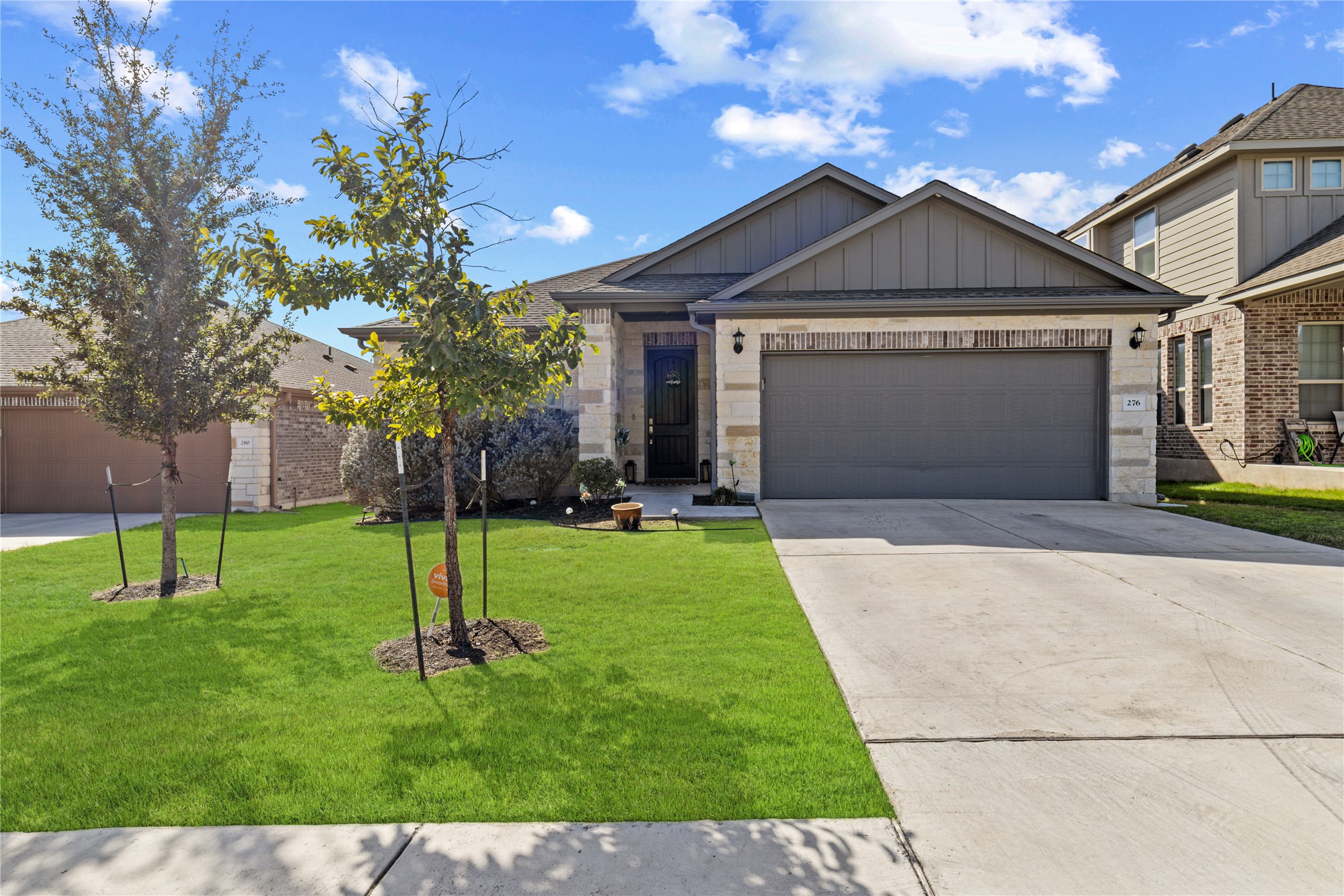 a front view of house with a garden