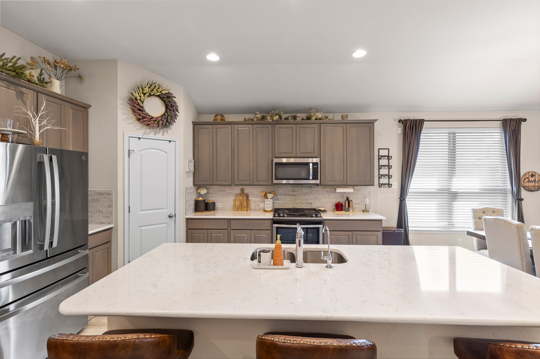 276 Finstown Street Hutto, TX 78634 - Photo 8 of 19 a kitchen with a refrigerator a stove a sink and a counter top space