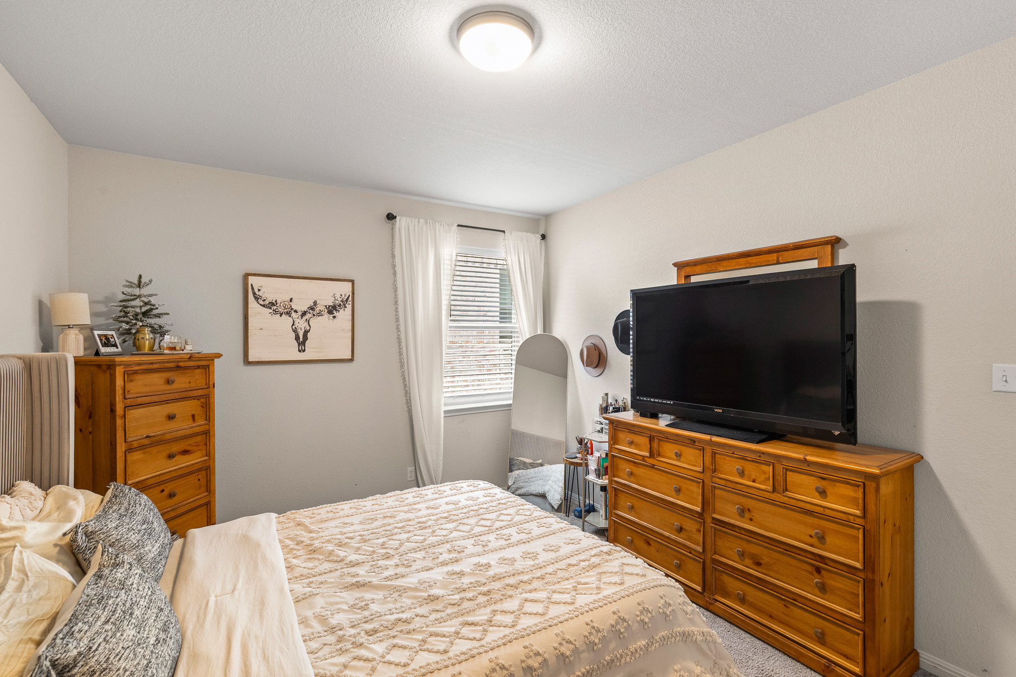 276 Finstown Street Hutto, TX 78634 - Photo 9 of 19 a bedroom with a bed and flat screen tv