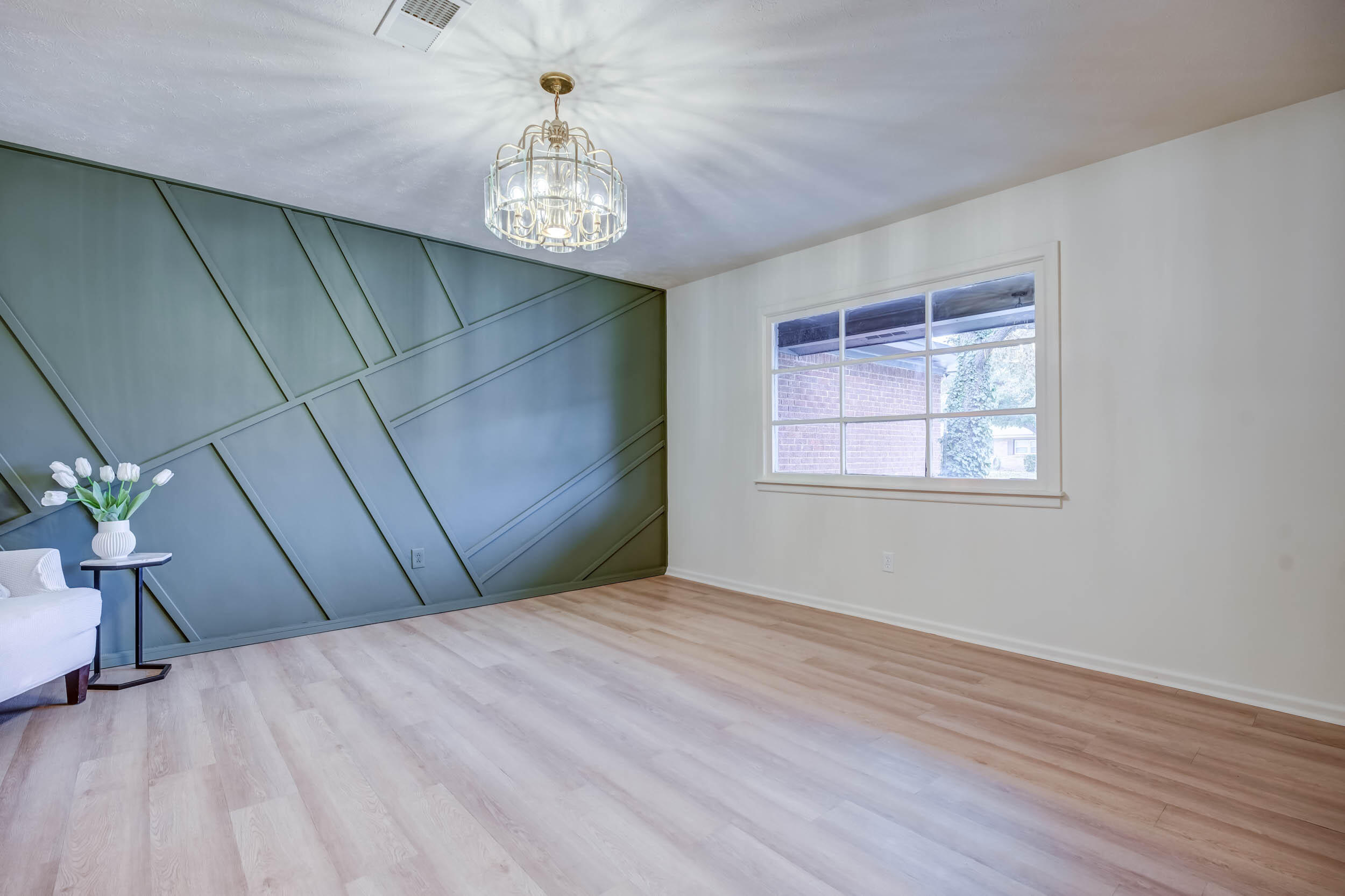 2101 64th Street Lubbock, TX 79412 - Photo 8 of 30 a view of an empty room with wooden floor and a window