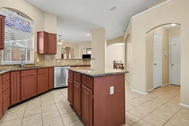 a kitchen with stainless steel appliances granite countertop a sink and cabinets