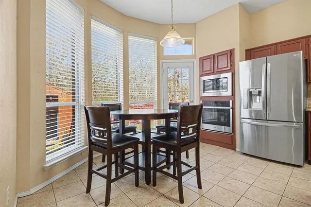 a view of a dining room with furniture and a chandelier