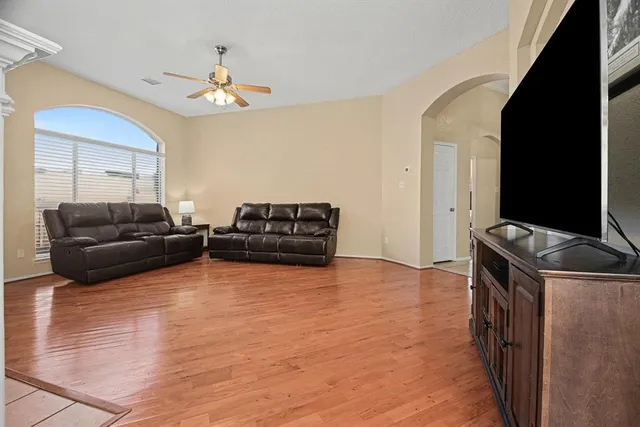 a living room with furniture and a flat screen tv