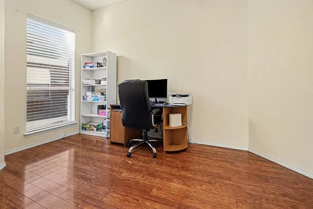 a view of workspace with furniture and wooden floor