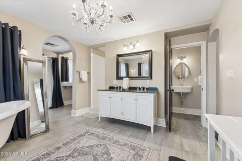 a bathroom with a sink a mirror and a shower