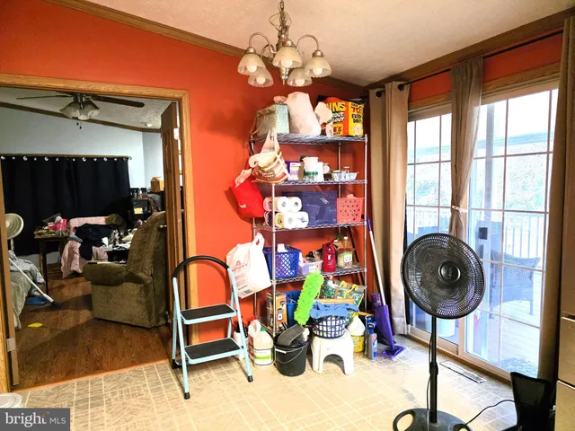 a view of a workspace with furniture and a chandelier