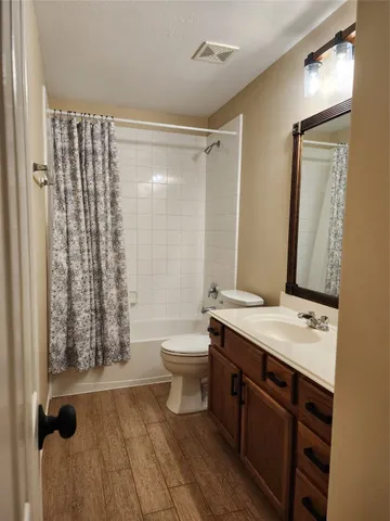 a view of an empty room with a chandelier fan
