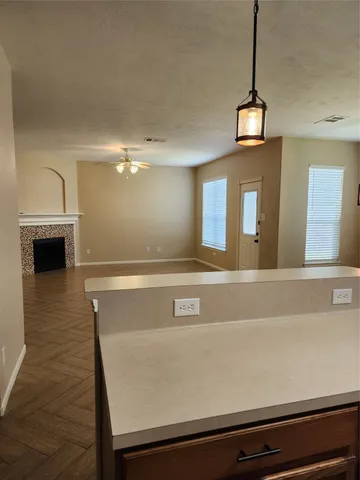 a view of a room with wooden floor