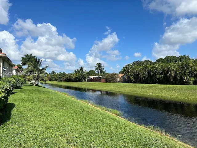 a view of a lake with houses in the background