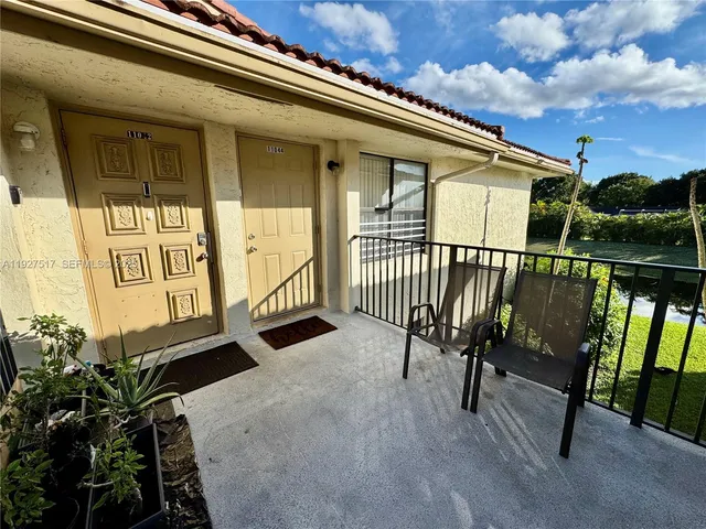 a view of balcony with wooden floor and fence