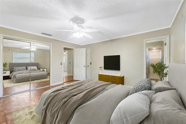 a bedroom with a bed and a flat screen tv