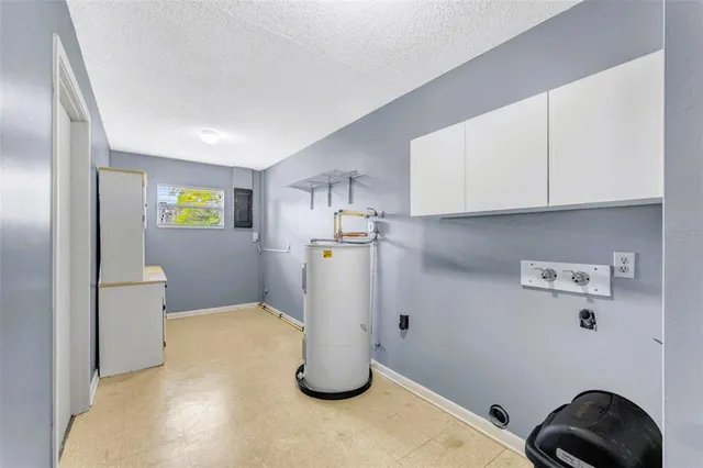 a view of a storage & utility room with refrigerator