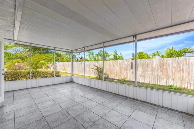 a view of a room with an empty space and plants