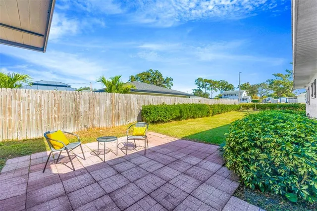 a view of a swimming pool with a lounge chair and a yard