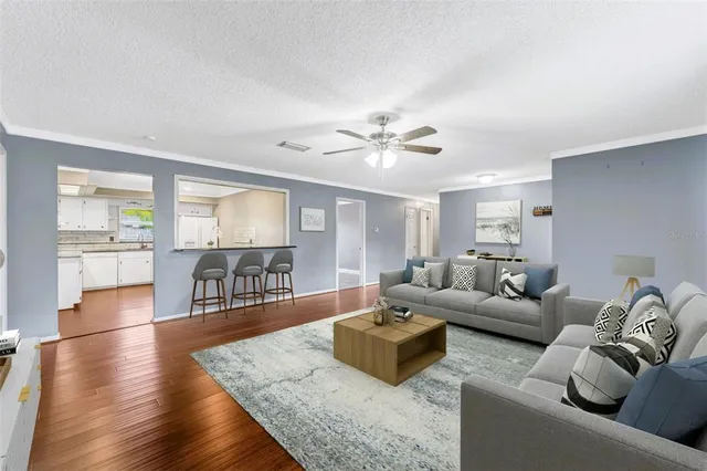 a living room with furniture and wooden floor