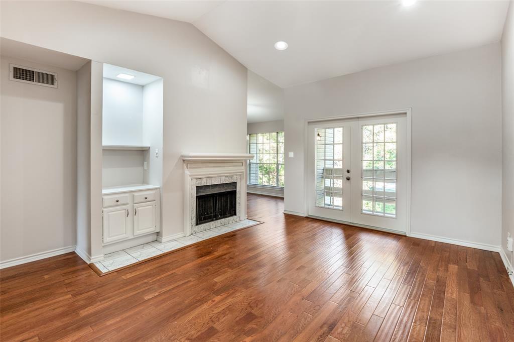6315 Campbell Road, Unit 510 Dallas, TX 75248 - Photo 2 of 11 a view of an empty room with wooden floor and a window