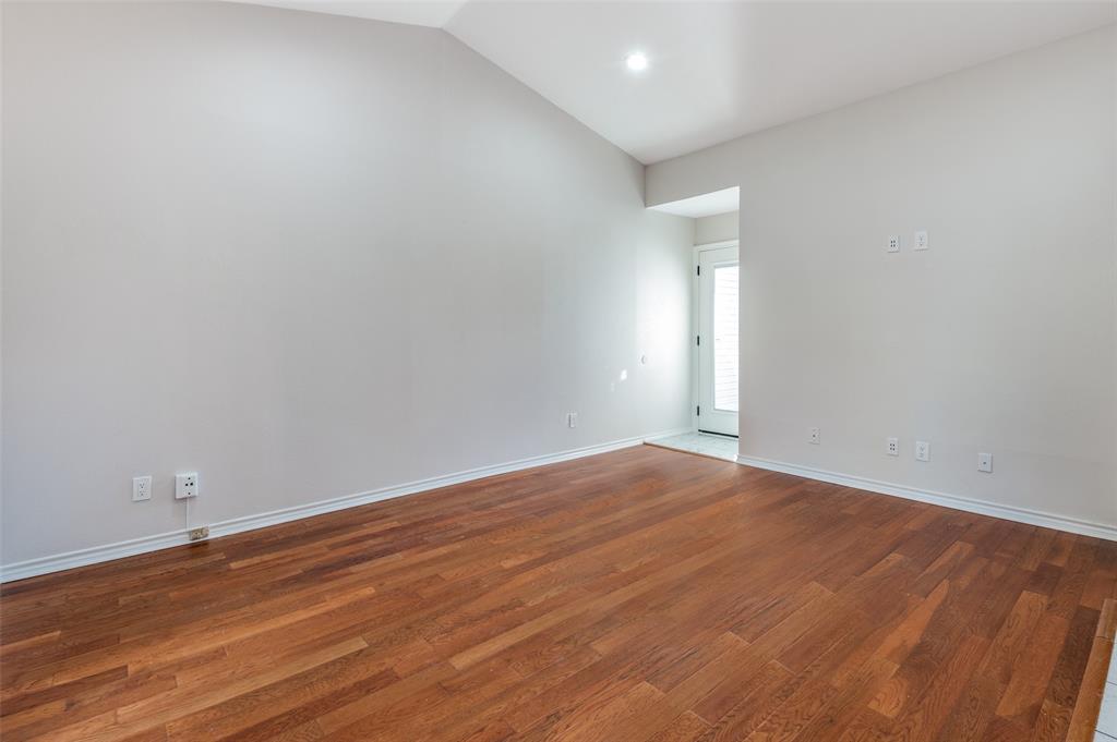 6315 Campbell Road, Unit 510 Dallas, TX 75248 - Photo 6 of 11 a view of an empty room with wooden floor and a window
