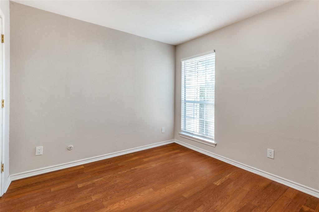6315 Campbell Road, Unit 510 Dallas, TX 75248 - Photo 9 of 11 an empty room with wooden floor and windows