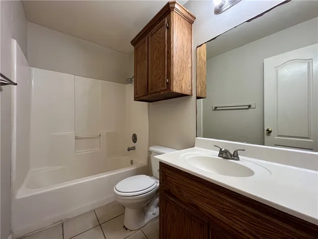 a bathroom with a sink a toilet and bathtub