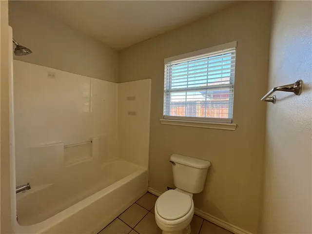 a bathroom with a toilet a sink and bathtub