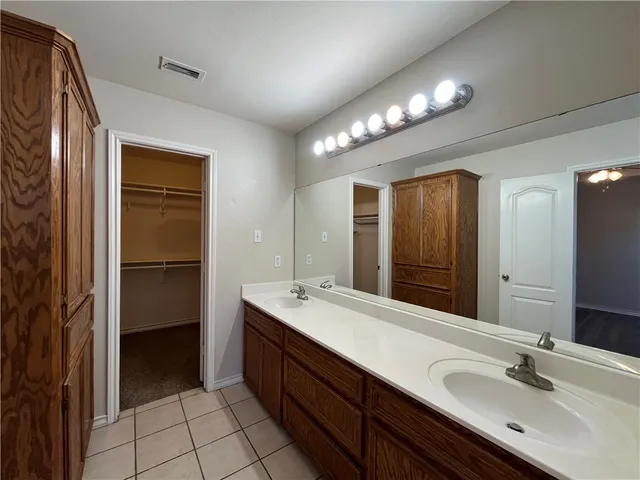 a bathroom with a sink double vanity and a mirror