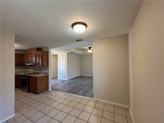 an empty room with kitchen appliances and cabinets