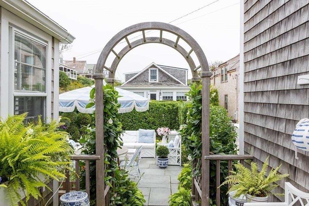 7 Bank Street Nantucket, MA 02554 - Photo 27 of 34 a front view of a house with a garden