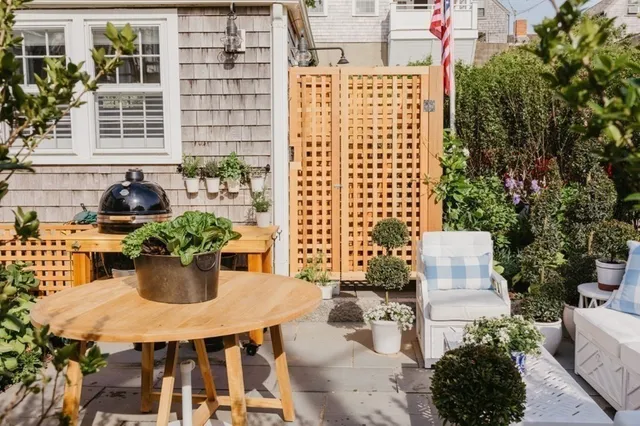 a view of a patio with a table chairs and a potted plant