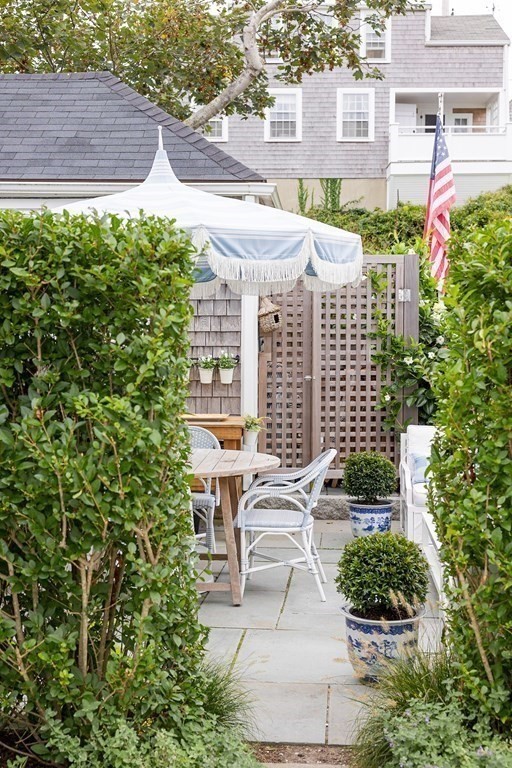 7 Bank Street Nantucket, MA 02554 - Photo 29 of 34 a view of a patio with table and chairs and potted plants