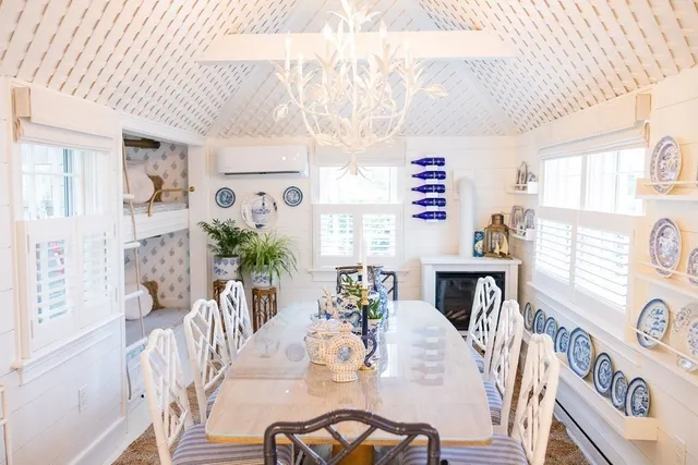 a view of a dining room with furniture a potted plant and wooden floor