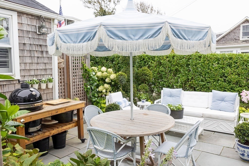 7 Bank Street Nantucket, MA 02554 - Photo 31 of 34 a view of a patio with a table chairs and a potted plant