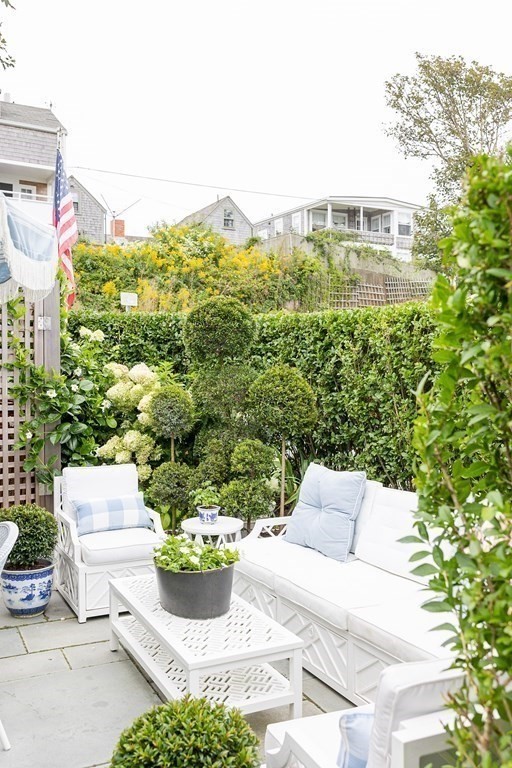 7 Bank Street Nantucket, MA 02554 - Photo 32 of 34 a view of a chairs and table in backyard