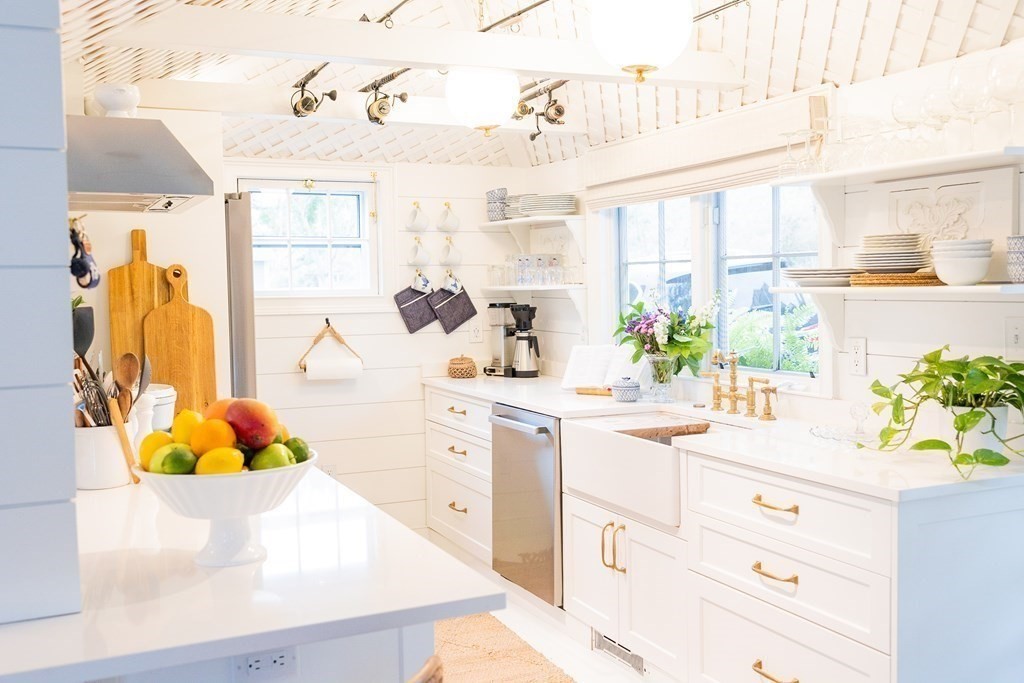 7 Bank Street Nantucket, MA 02554 - Photo 7 of 34 a kitchen with a sink stove and cabinets