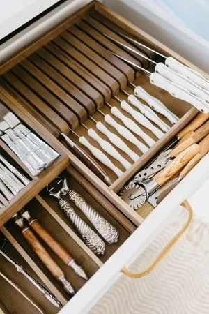 a white sink sitting next to a white wall
