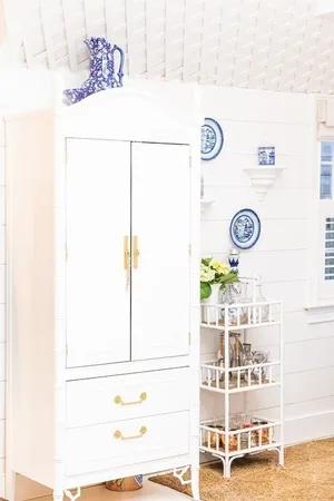 a view of a dinning table with paintings on the wall