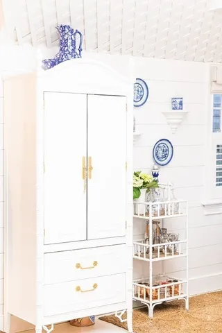 a view of a dinning table with paintings on the wall