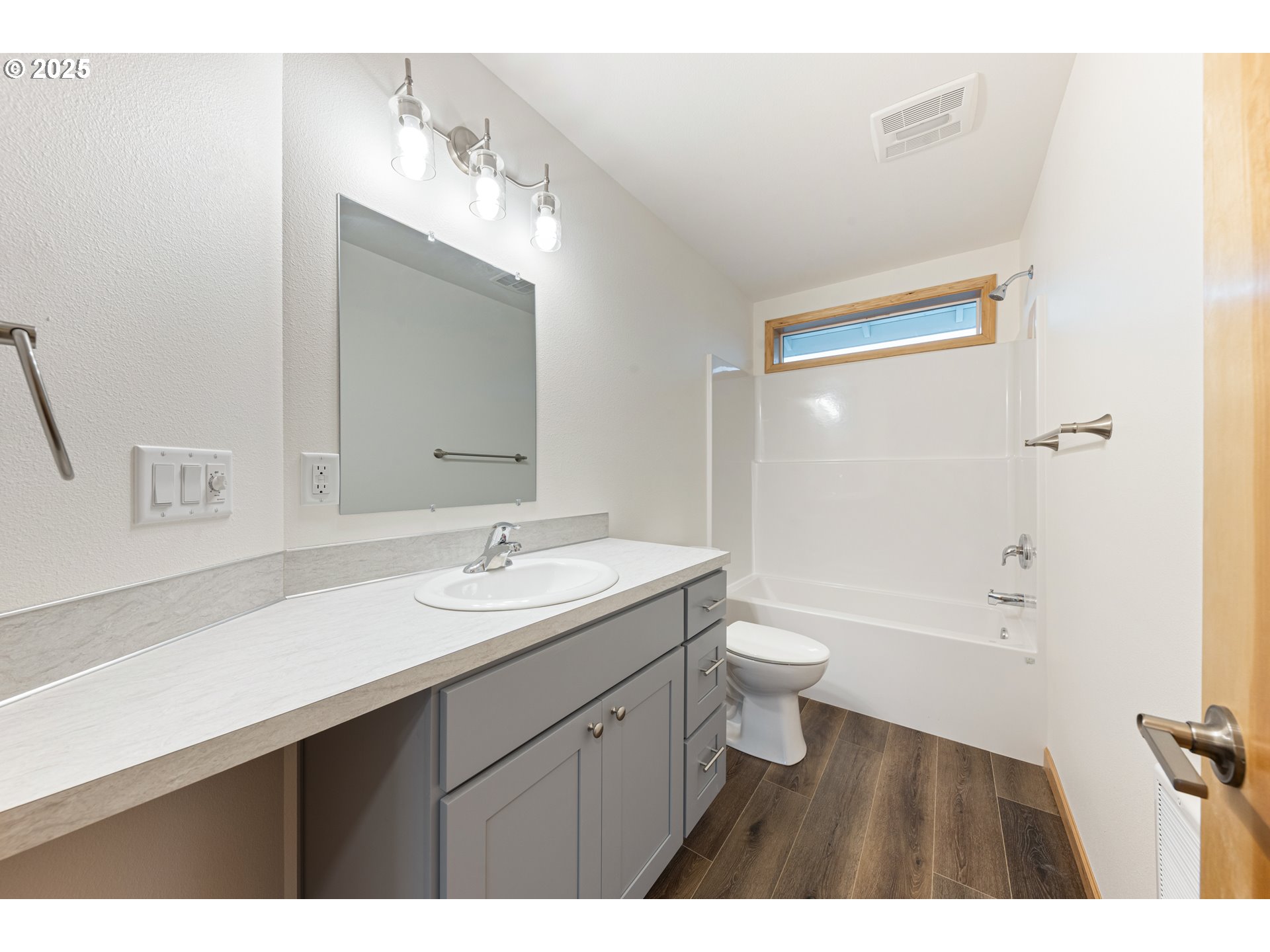 671 ST Charles Street Eugene, OR 97402 - Photo 24 of 29 a bathroom with a granite countertop sink toilet a large mirror a bathtub and shower