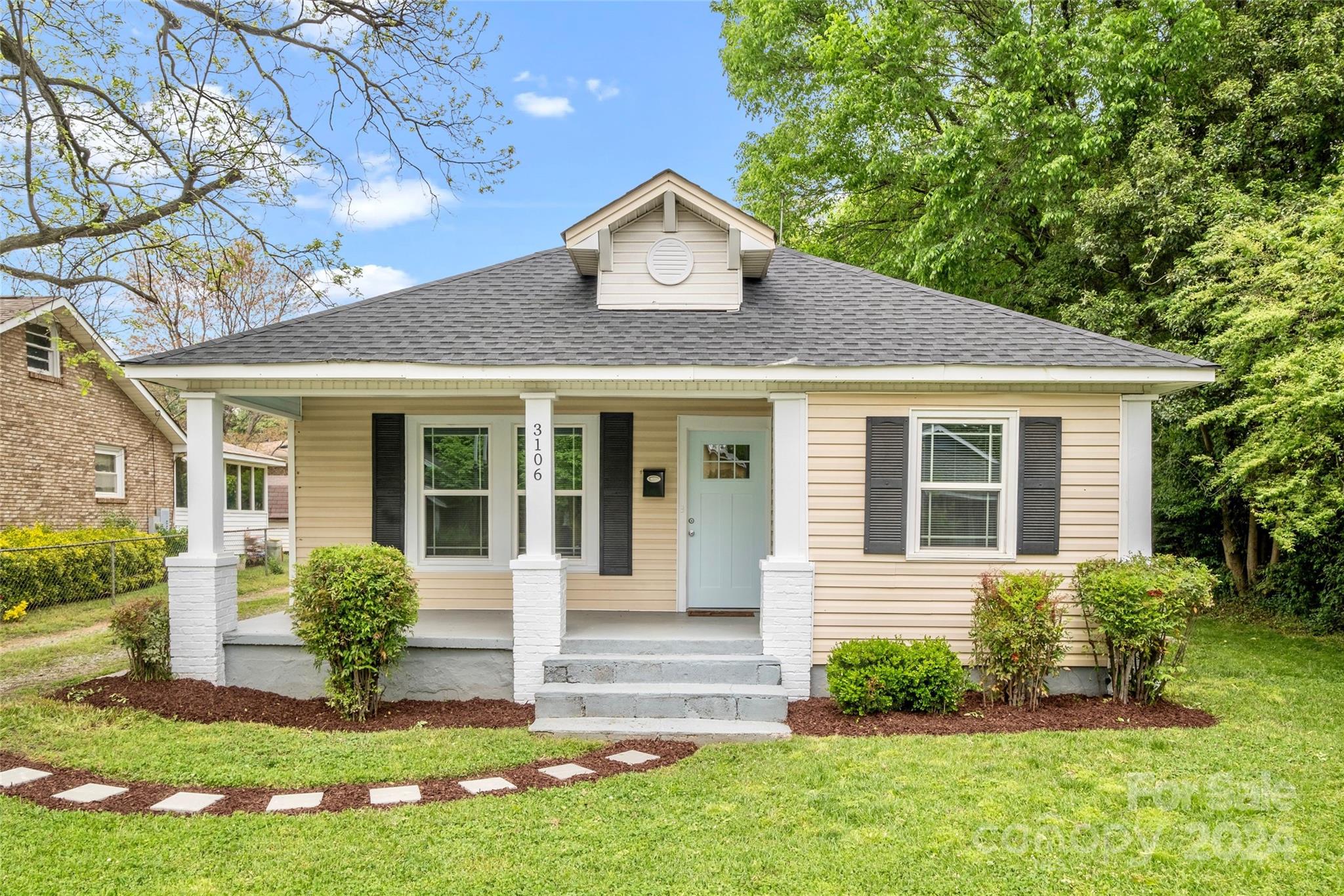 3106 Tuckaseegee Road Charlotte, NC 28208 - Photo 1 of 44 a front view of a house with a yard