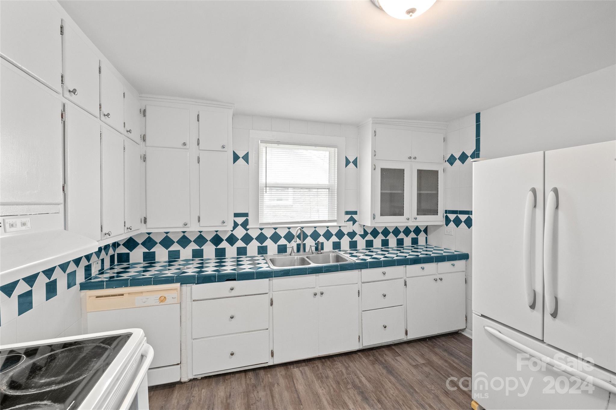 3106 Tuckaseegee Road Charlotte, NC 28208 - Photo 11 of 44 a kitchen with granite countertop white cabinets and white appliances
