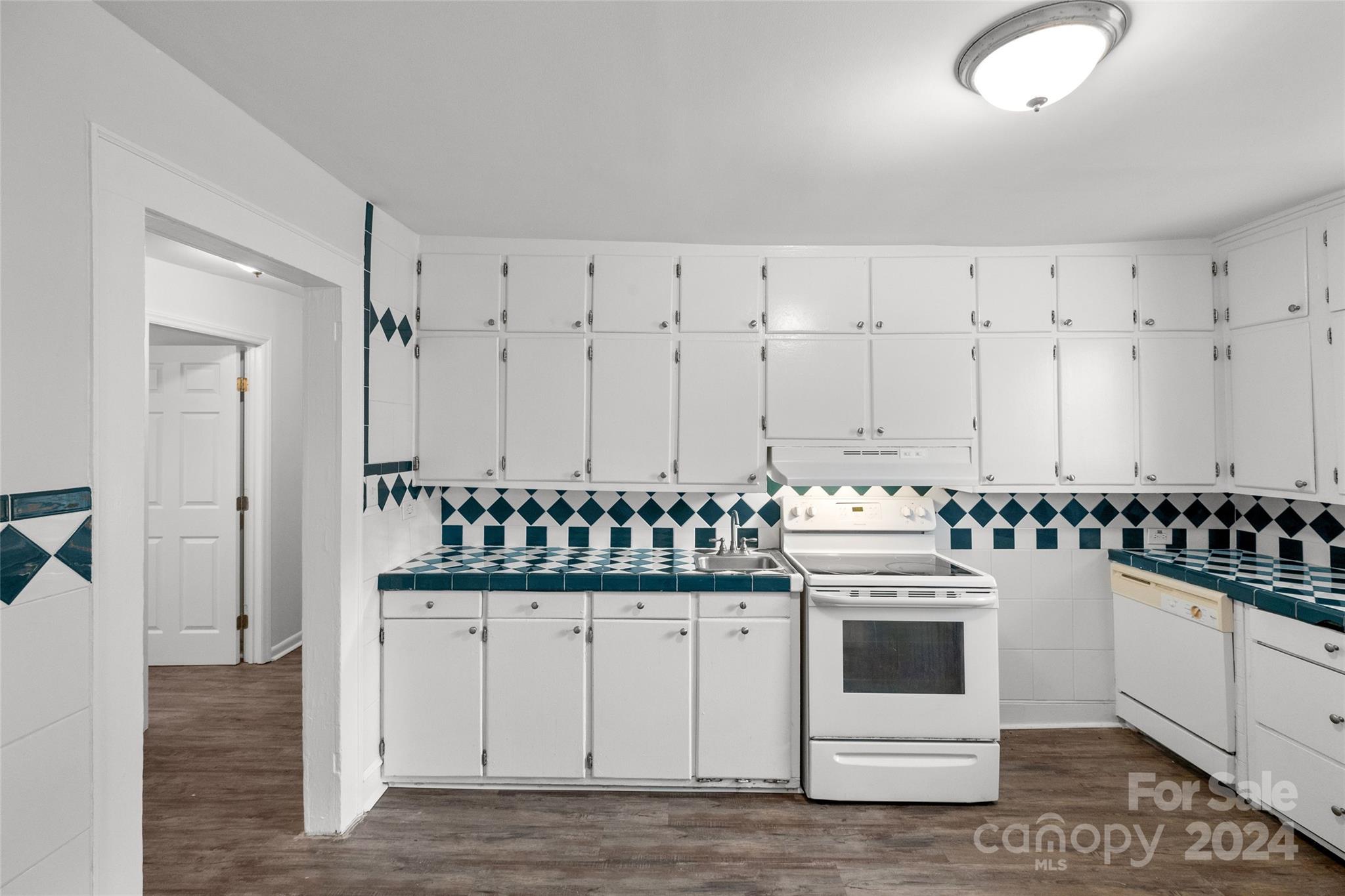 3106 Tuckaseegee Road Charlotte, NC 28208 - Photo 13 of 44 a kitchen with appliances a stove a sink and cabinets