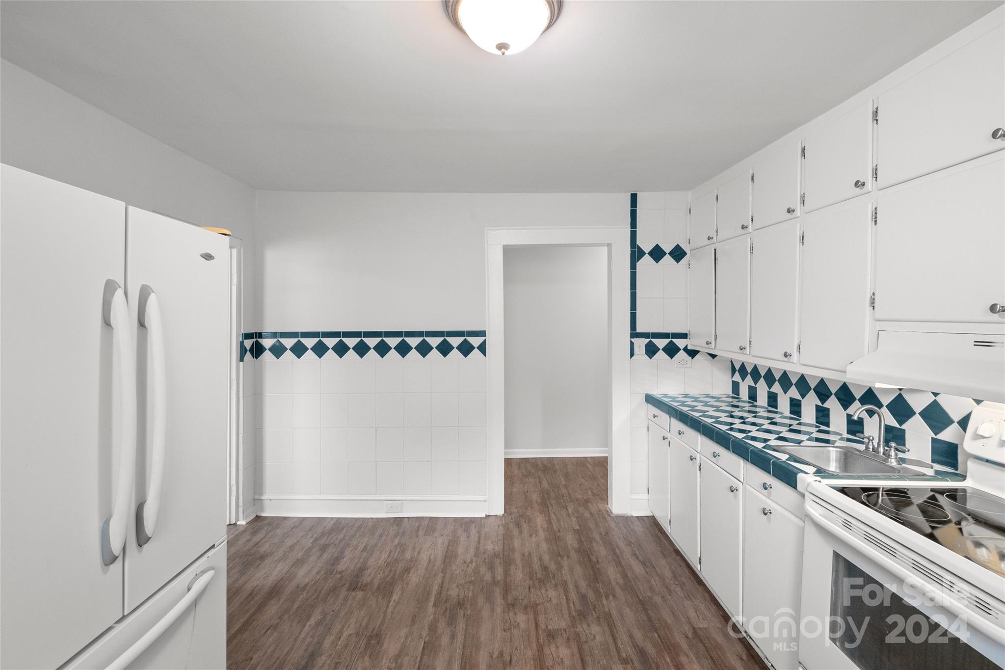 3106 Tuckaseegee Road Charlotte, NC 28208 - Photo 15 of 44 a kitchen with stainless steel appliances a white cabinets and a sink