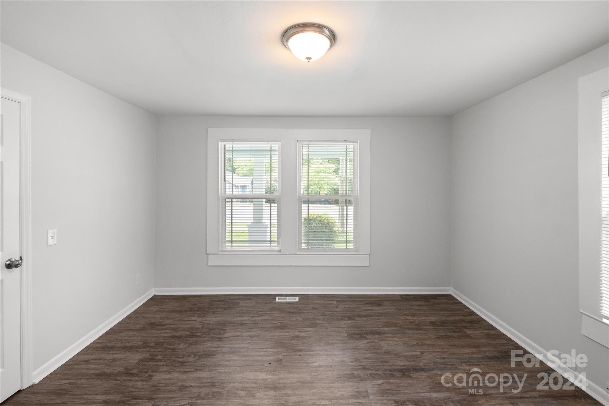 3106 Tuckaseegee Road Charlotte, NC 28208 - Photo 16 of 44 an empty room with wooden floor and windows