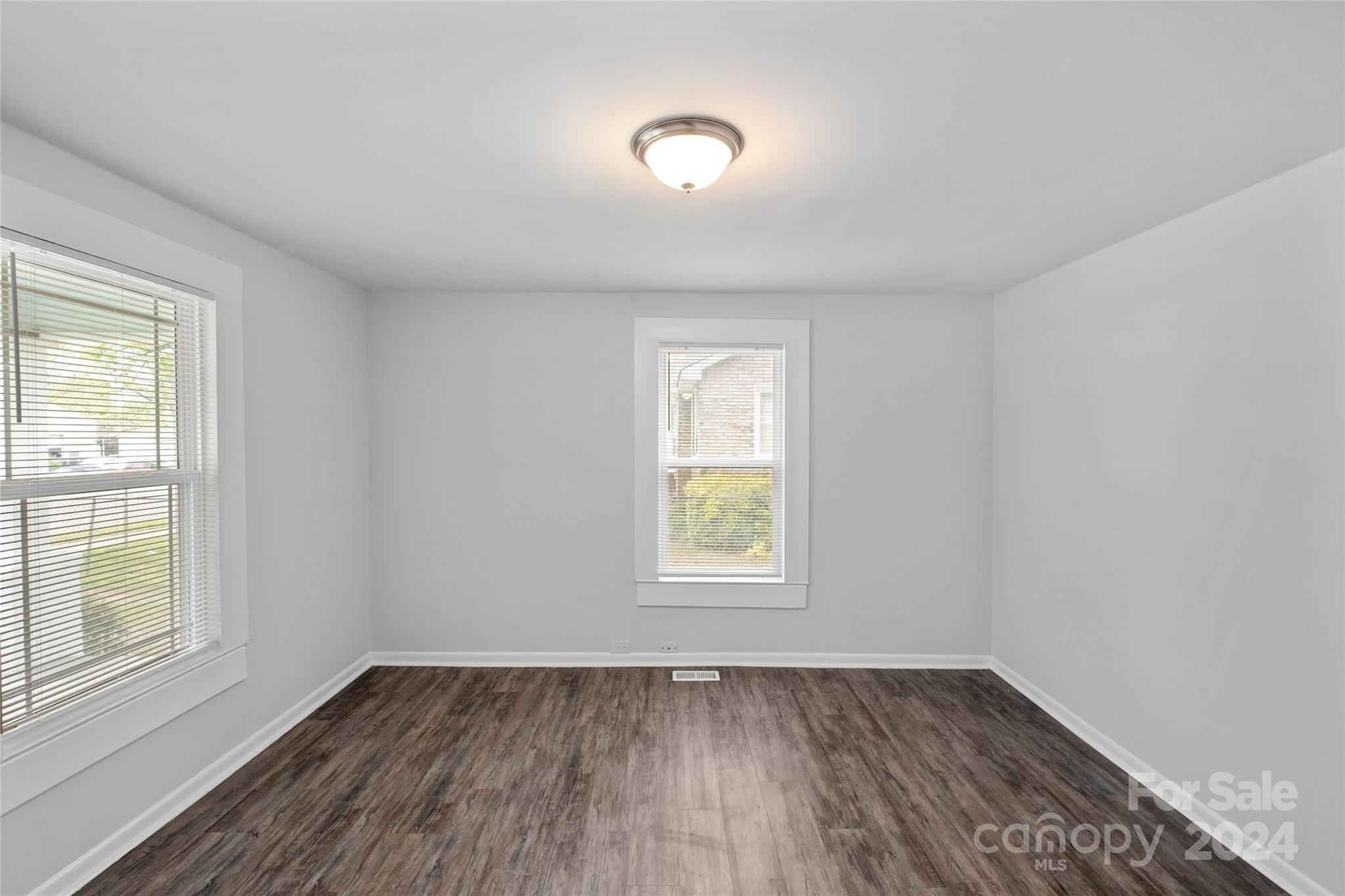 3106 Tuckaseegee Road Charlotte, NC 28208 - Photo 17 of 44 an empty room with wooden floor and windows