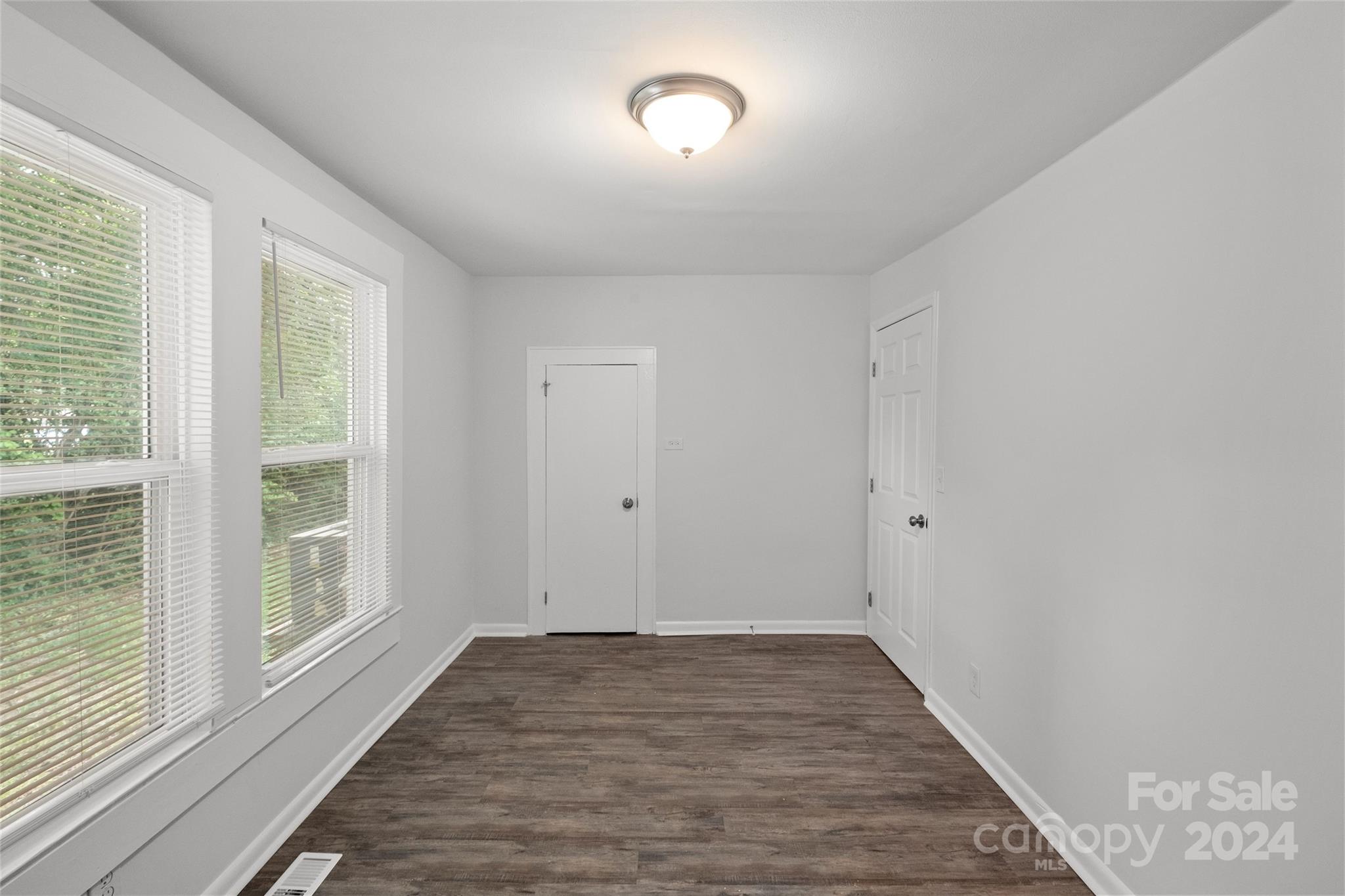 3106 Tuckaseegee Road Charlotte, NC 28208 - Photo 21 of 44 a view of an empty room with wooden floor and a window